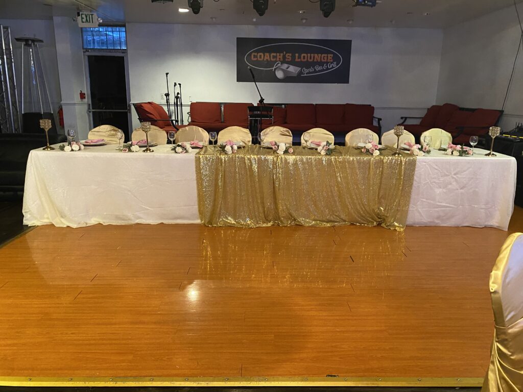 Long decorated head table with gold runner